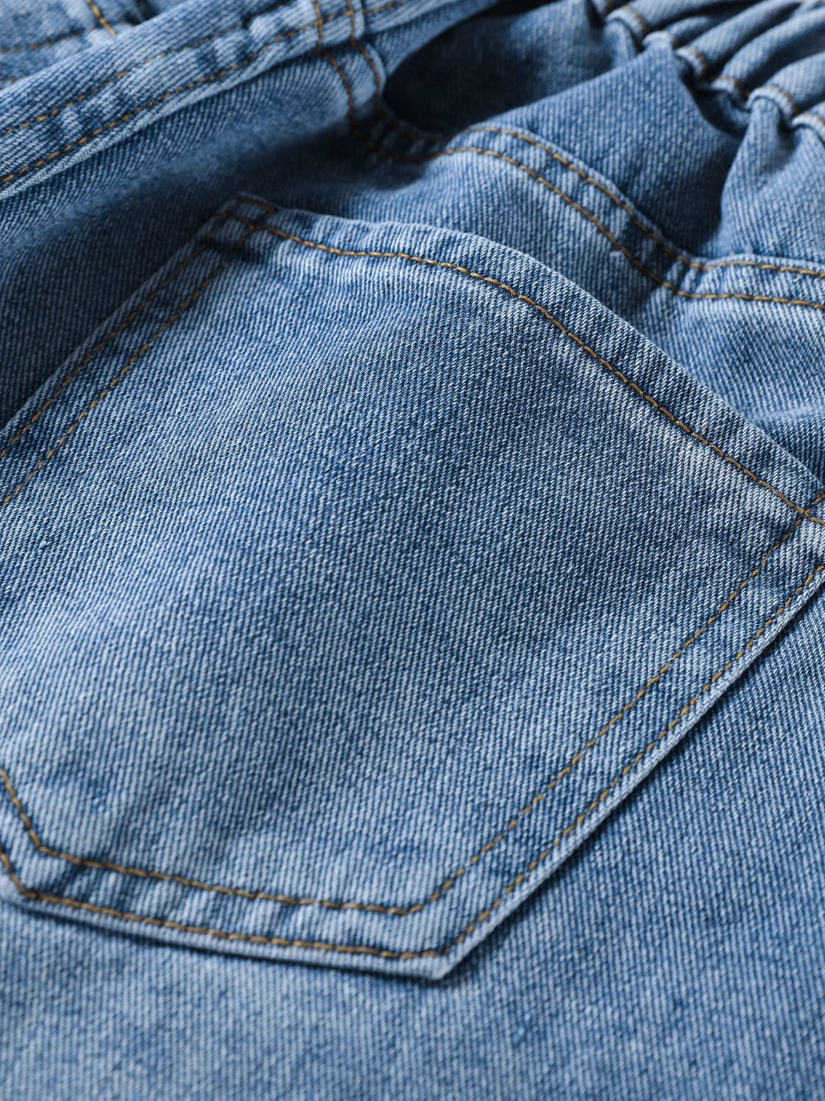 YEEYEEWang Denim Bermuda Shorts in Blue, Asian-fit cut, close-up of back patch pocket with contrast topstitching on washed denim twill.