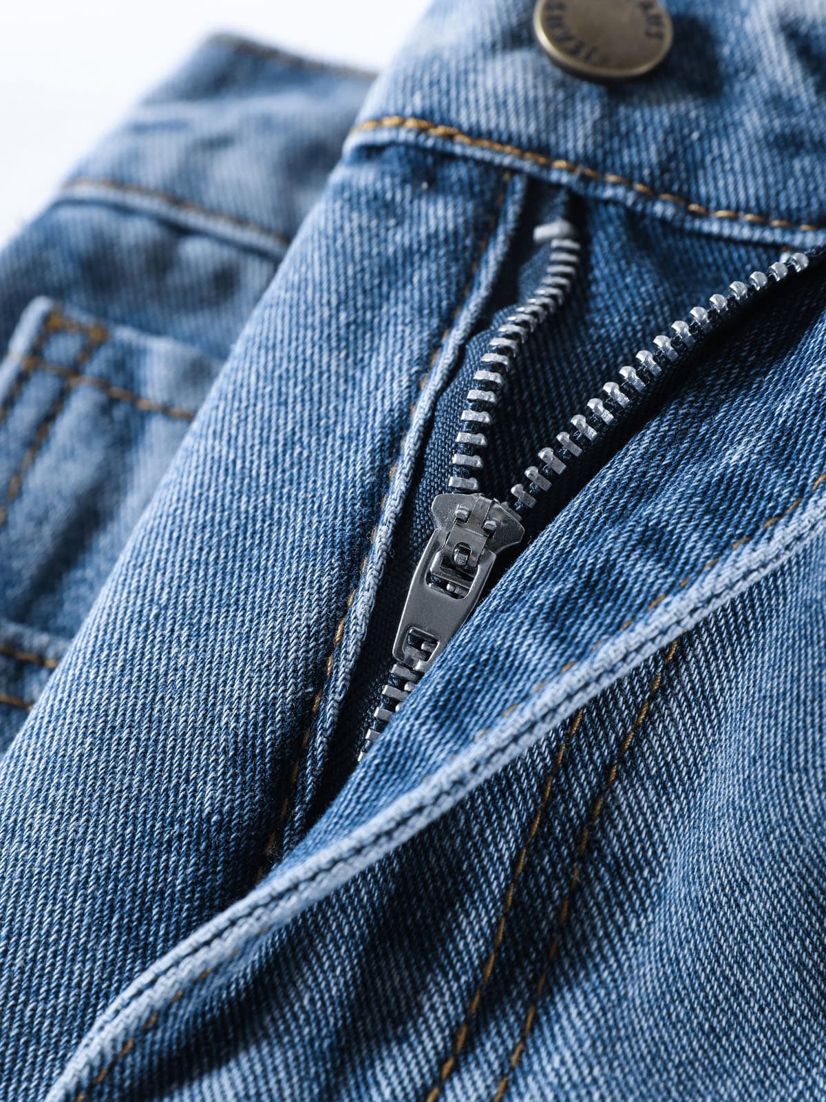YEEYEEWang Denim Bermuda Shorts in Blue, Asian-fit cut, close-up of silver-tone zipper fly with antique bronze button and denim twill texture.