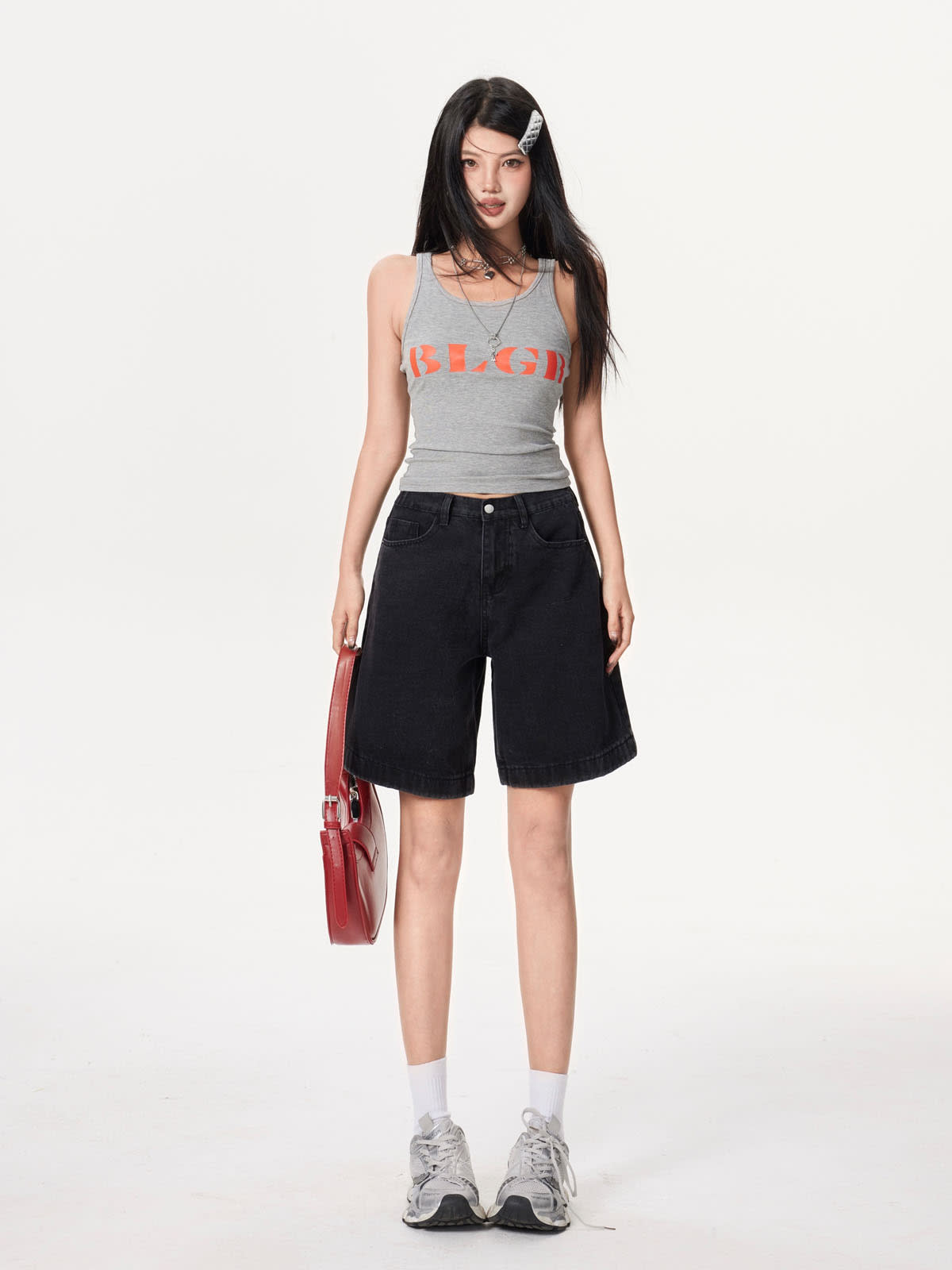 YEEYEEWang Denim Bermuda Shorts in Solid Black, Asian-fit cut, full-body front standing pose holding a red shoulder bag, grey tank top and sneakers.