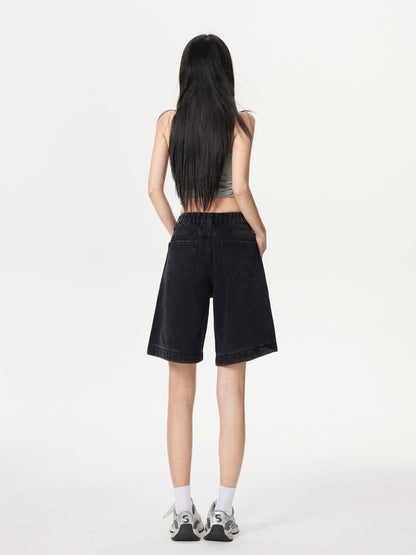 YEEYEEWang Denim Bermuda Shorts in Solid Black, Asian-fit cut, full-body back standing view showing back patch pockets and elastic-back waistband with sneakers.