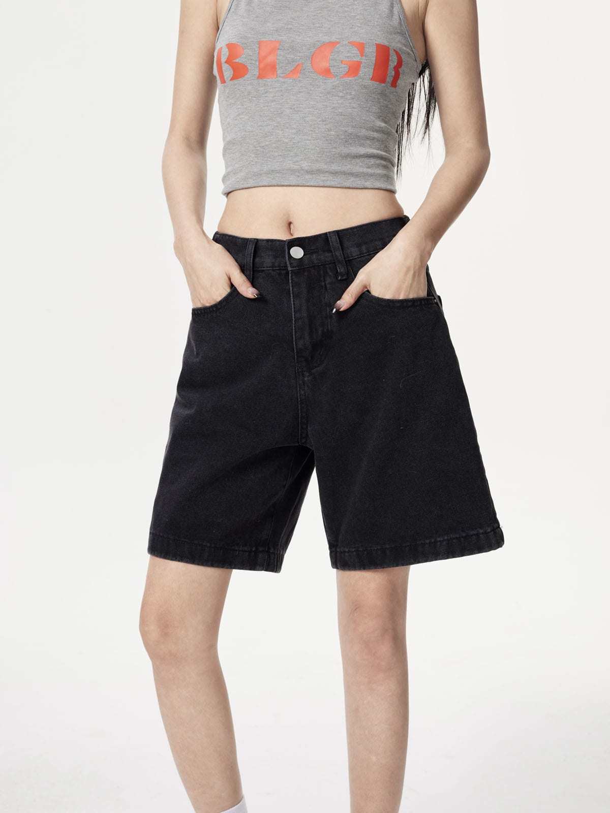 YEEYEEWang Denim Bermuda Shorts in Solid Black, Asian-fit cut, waist-down front view, hands in front pockets, metal button at waistband.