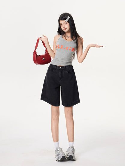 YEEYEEWang Denim Bermuda Shorts in Solid Black, Asian-fit cut, full-body front standing pose, holding a red shoulder bag, other hand extended.