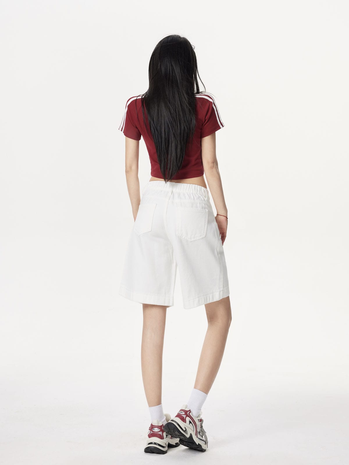 YEEYEEWang Denim Bermuda Shorts in Ivory, Asian-fit cut, full-body back view standing, elastic back waistband and back patch pockets visible.
