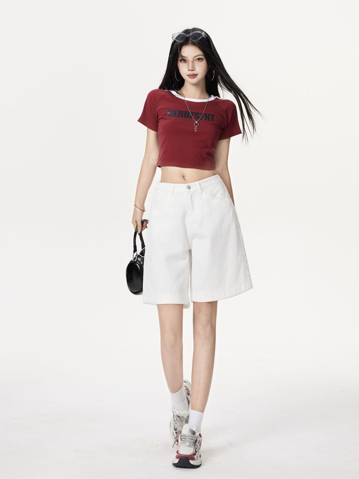 YEEYEEWang Denim Bermuda Shorts in Ivory, Asian-fit cut, full-body front standing pose, holding a black handbag at side.