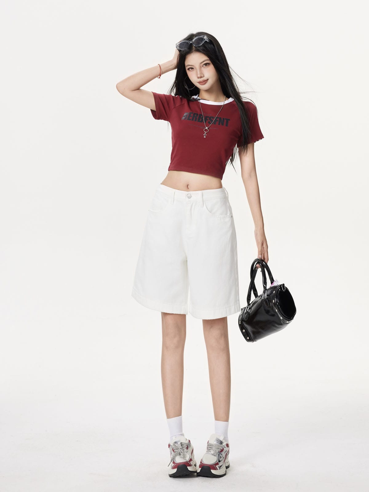 YEEYEEWang Denim Bermuda Shorts in Ivory, Asian-fit cut, full-body front standing pose, one hand raised to head, black handbag in other hand.