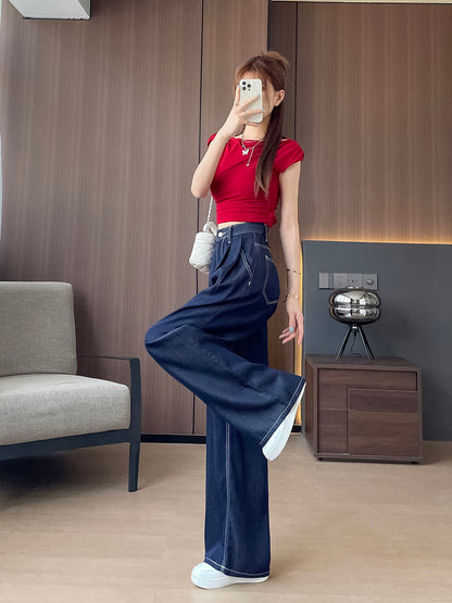YEEYEEWang Wide-Leg Jeans in Denim Blue, Asian-fit cut, full-body side leg-kick pose holding phone at face, red crop top and white chain bag.