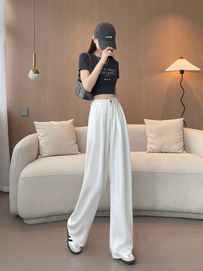 YEEYEEWang Wide-Leg Jeans in White, Asian-fit cut, full-body walking pose with legs crossed mid-step, one hand raised near face, gray shoulder bag.