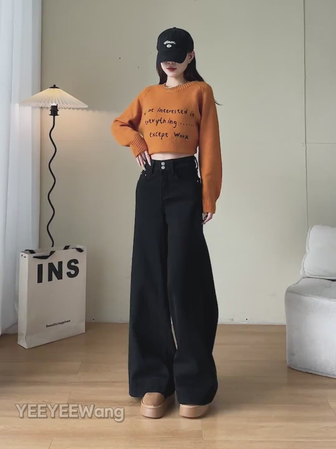YEEYEEWang Wide-Leg jeans video Fleece-Lined in Solid Black: Asian model stands, pockets hands and lifts leg showing drapey fit, camera zooms to waist, then she folds hem to reveal thick grey fleece.