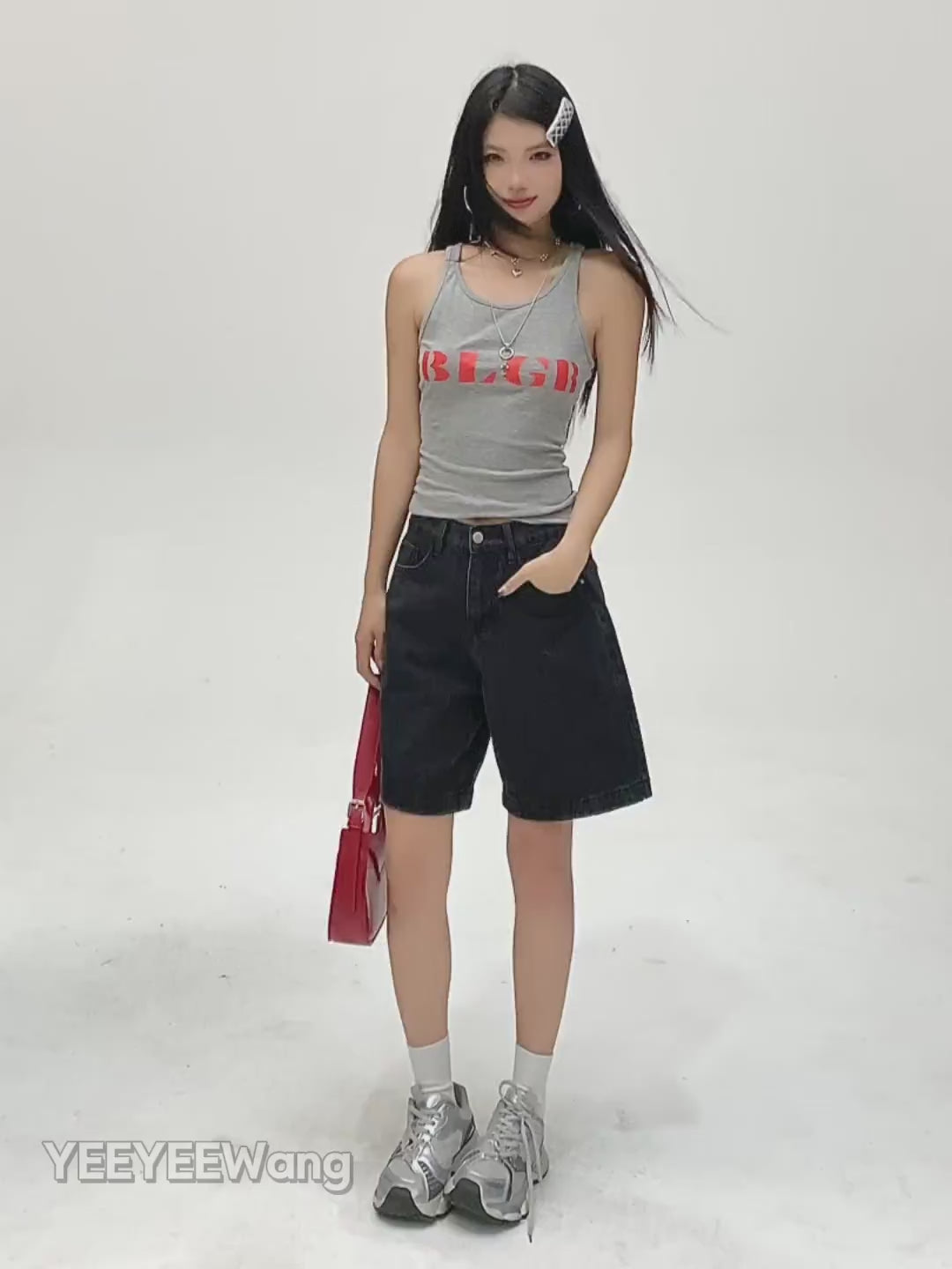 YEEYEEWang Denim Bermuda Shorts in Solid Black video: Asian model does 360 turns, side poses and hands-on-hips back view, showing high-waist relaxed straight cut, knee length and elastic back waist.