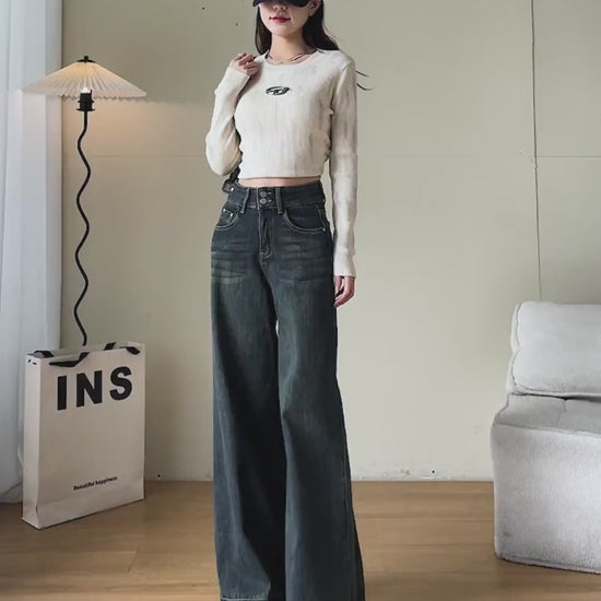 YEEYEEWang Wide-Leg jeans video in Mid-Wash Blue: Asian model walks showing drapey wide-leg fit, camera zooms to double-button high waist, five pockets and cuffed hems as she lifts the leg.