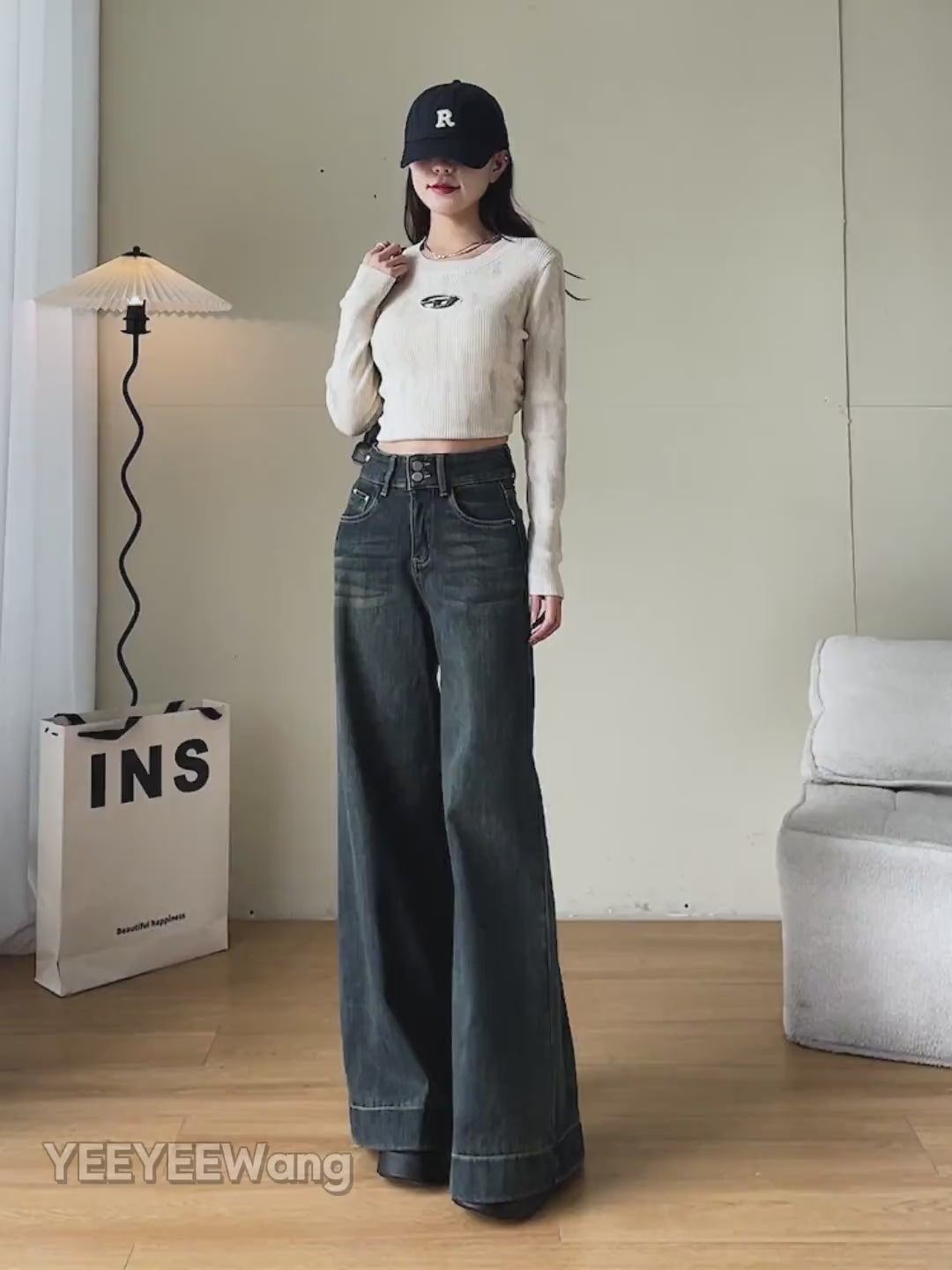 YEEYEEWang Wide-Leg jeans video in Mid-Wash Blue: Asian model walks showing drapey wide-leg fit, camera zooms to double-button high waist, five pockets and cuffed hems as she lifts the leg.