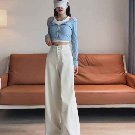 YEEYEEWang Wide-Leg jeans video in Ivory: Asian model walks and shifts poses showing floor-length drapey wide-leg fit, camera zooms to double-button high waist as she slips hands into pockets.