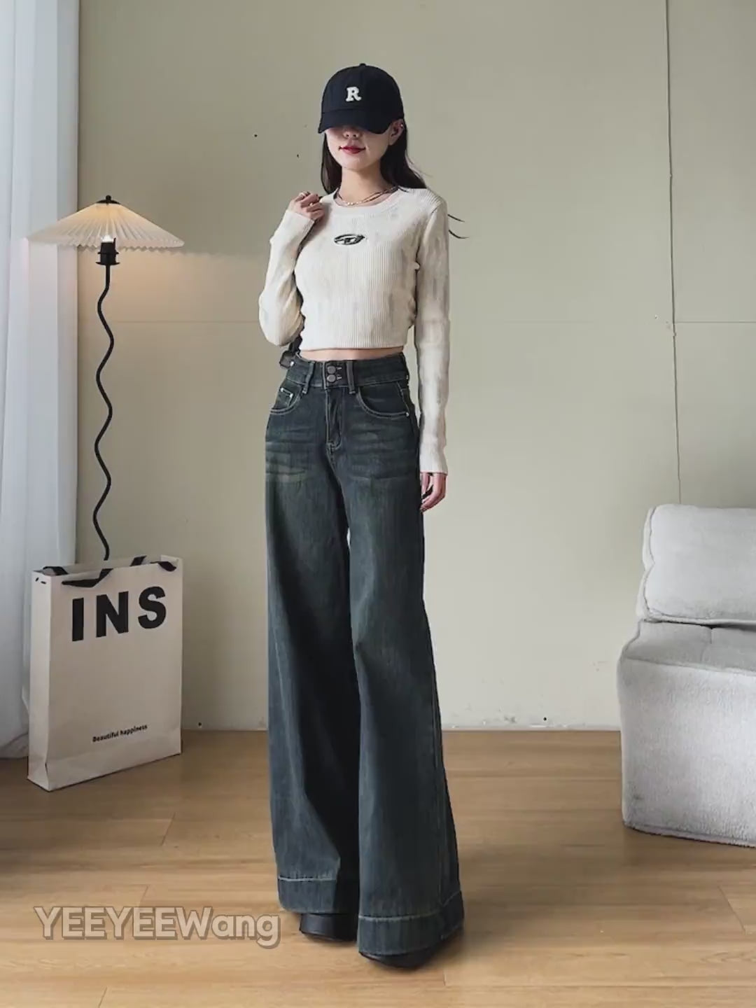 YEEYEEWang Wide-Leg jeans video Fleece-Lined in Mid-Wash Blue: Asian model walks showing drapey fit, zooms to high waist and cuffed hem, lifts leg to reveal thick fleece lining, stroking it.