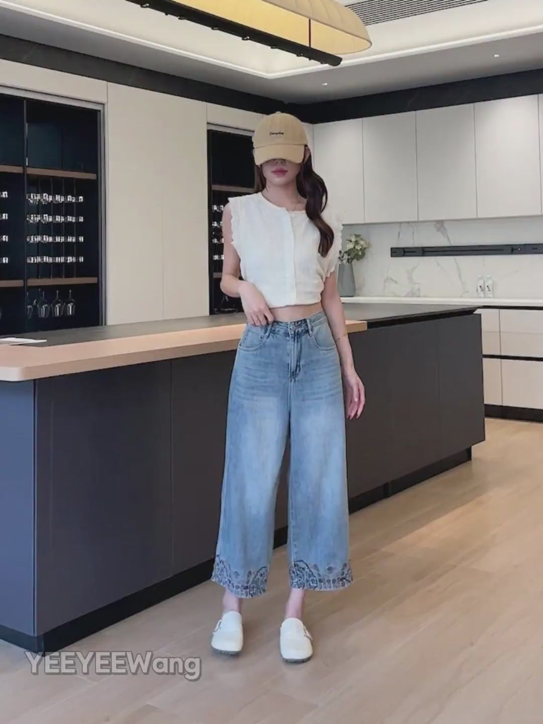 YEEYEEWang Wide-Leg Jeans video in Light Blue: Asian model leans and lifts leg in a modern kitchen, showing high-rise wide-leg drape and floral hem embroidery.
