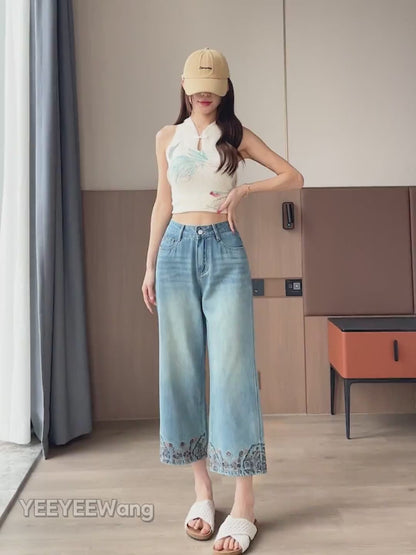 YEEYEEWang Straight jeans in Vintage Blue video: Asian model walks and poses in high-waist wide-leg jeans, showing drape, floral embroidered hems and faded wash under natural light.