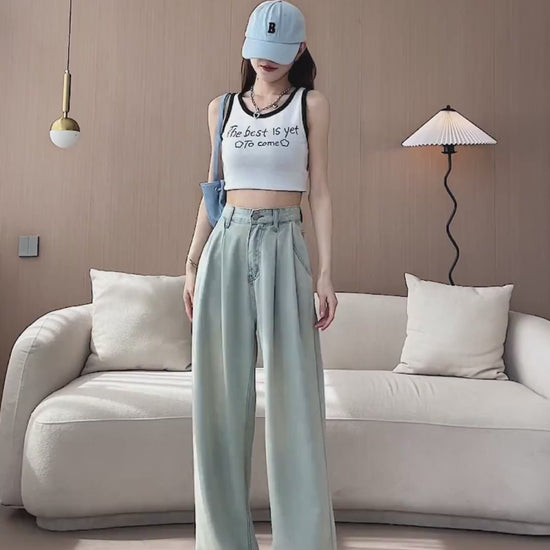 YEEYEEWang Wide-Leg jeans video: Asian model in Light Blue stands with hands in pockets and lifts leg, camera zooms in on high waist, front pockets and relaxed stacking hem with soft draping fabric