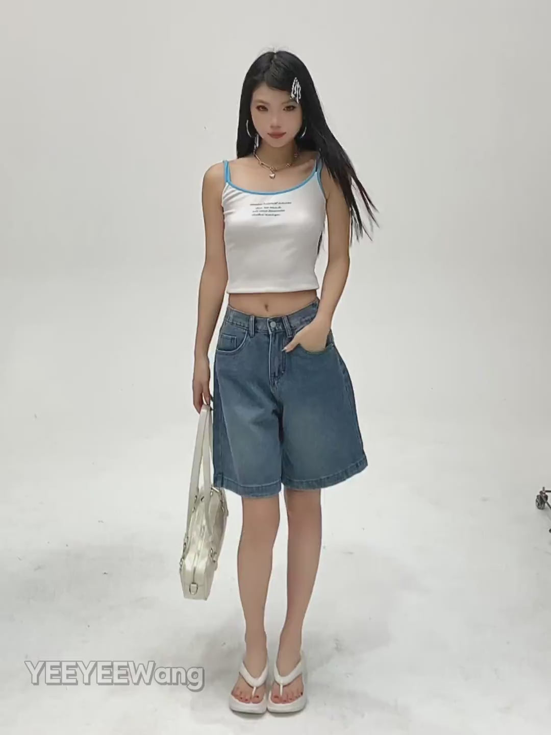YEEYEEWang Denim Bermuda Shorts in Blue video: Asian model walks, turns and poses hands-in-pockets, showing high-waist wide-leg drape, elastic back waist, five pockets and rolled cuffs.